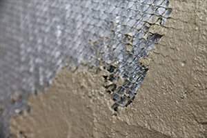 Applying PB02 base coat with notched trowel for EPS board installation